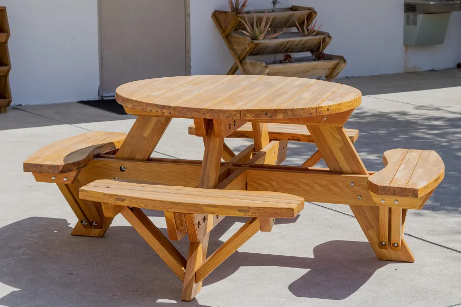 Round Wooden Picnic Table (Attached Benches) (Options: 4' Diameter, Attached Benches, Mosaic Douglas-Fir, Standard Tabletop, No Lazy Susan, No Umbrella Hole, Transparent Premium Sealant). Photo courtesy of Vanguard University [55 Fair Dr, Costa Mesa, CA].