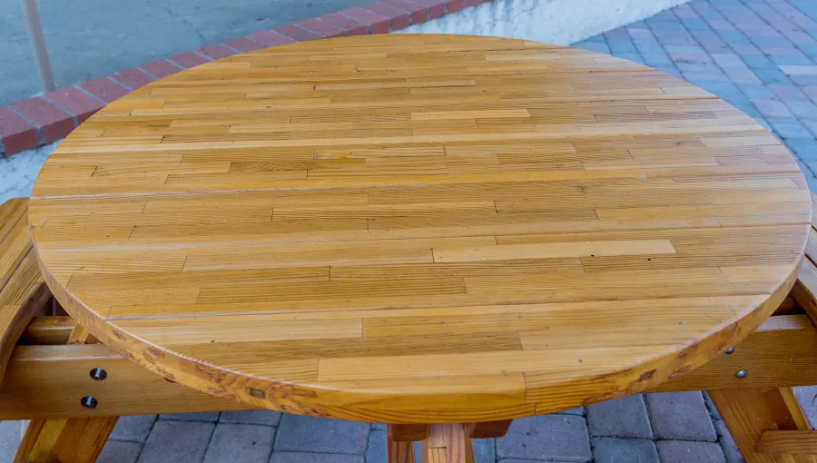 Round Wooden Picnic Table (Attached Benches) (Options: 4' Diameter, Attached Benches, Mosaic Douglas-Fir, Standard Tabletop, No Lazy Susan, No Umbrella Hole, Transparent Premium Sealant). Photo courtesy of Vanguard University [55 Fair Dr, Costa Mesa, CA].