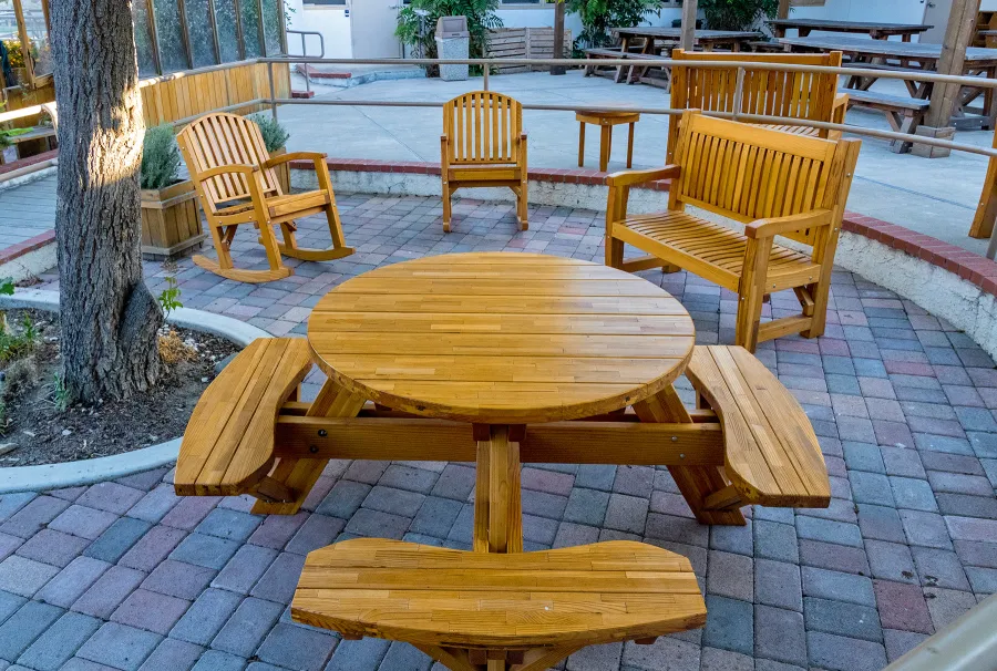 Round Wooden Picnic Table (Attached Benches) (Options: 4' Diameter, Attached Benches, Mosaic Douglas-Fir, Standard Tabletop, No Lazy Susan, No Umbrella Hole, Transparent Premium Sealant). Photo courtesy of Vanguard University [55 Fair Dr, Costa Mesa, CA].