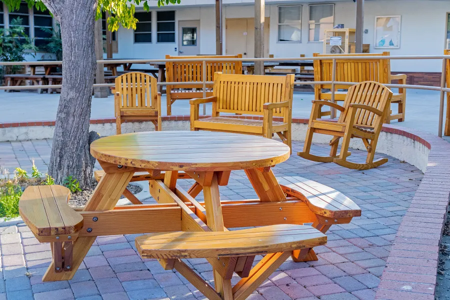 Round Wooden Picnic Table (Attached Benches) (Options: 4' Diameter, Attached Benches, Mosaic Douglas-Fir, Standard Tabletop, No Lazy Susan, No Umbrella Hole, Transparent Premium Sealant). Photo courtesy of Vanguard University [55 Fair Dr, Costa Mesa, CA].