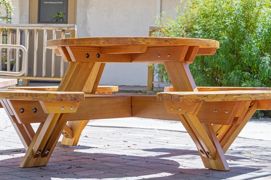 Round Wooden Picnic Table (Attached Benches) (Options: 4' Diameter, Attached Benches, Mosaic Douglas-Fir, Standard Tabletop, No Lazy Susan, No Umbrella Hole, Transparent Premium Sealant). Photo courtesy of Vanguard University [55 Fair Dr, Costa Mesa, CA].