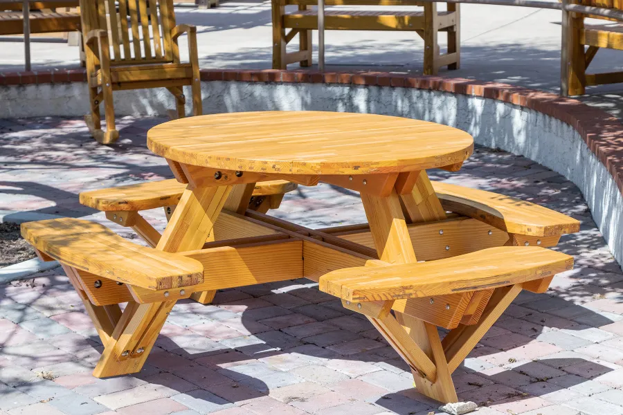 Round Wooden Picnic Table (Attached Benches) (Options: 4' Diameter, Attached Benches, Mosaic Douglas-Fir, Standard Tabletop, No Lazy Susan, No Umbrella Hole, Transparent Premium Sealant). Photo courtesy of Vanguard University [55 Fair Dr, Costa Mesa, CA].