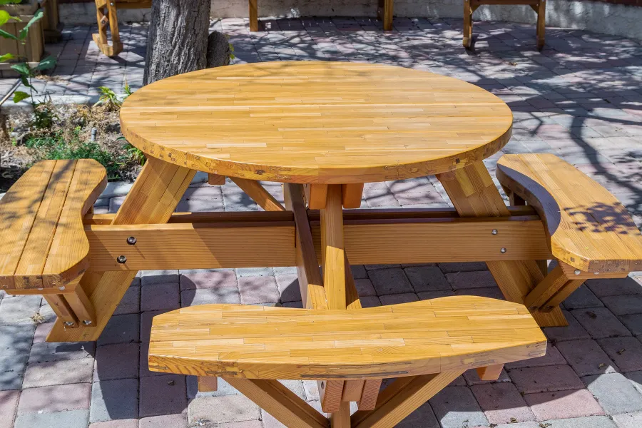 Round Wooden Picnic Table (Attached Benches) (Options: 4' Diameter, Attached Benches, Mosaic Douglas-Fir, Standard Tabletop, No Lazy Susan, No Umbrella Hole, Transparent Premium Sealant). Photo courtesy of Vanguard University [55 Fair Dr, Costa Mesa, CA].