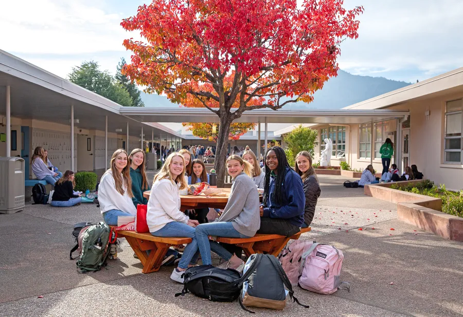Round Wooden Picnic Tables (Attached Benches) (Options: 5' Diameter, Attached Benches, Douglas-fir, Standard Tabletop, No Lazy Susan, No Umbrella Hole, Transparent Premium Sealant). Photo Courtesy of Marin Catholic High School in Kentfield, CA.