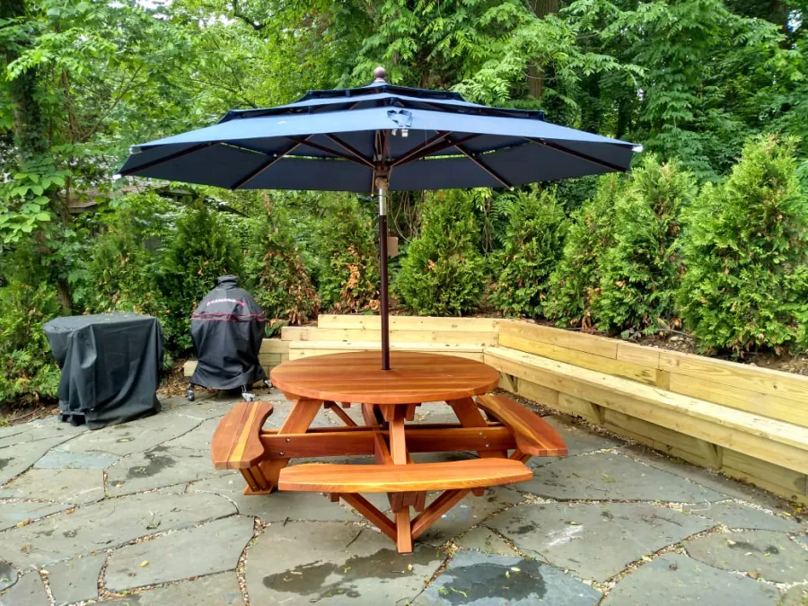 Round Wooden Picnic Tables (Attached Benches) (Options: 5' Diameter, Attached Benches, California Redwood, Standard Tabletop, No Lazy Susan, 1 5/8 Umbrella Hole & Plug, Transparent Premium Sealant). Photo Courtesy of S. Shilagani of Great Neck, New York.