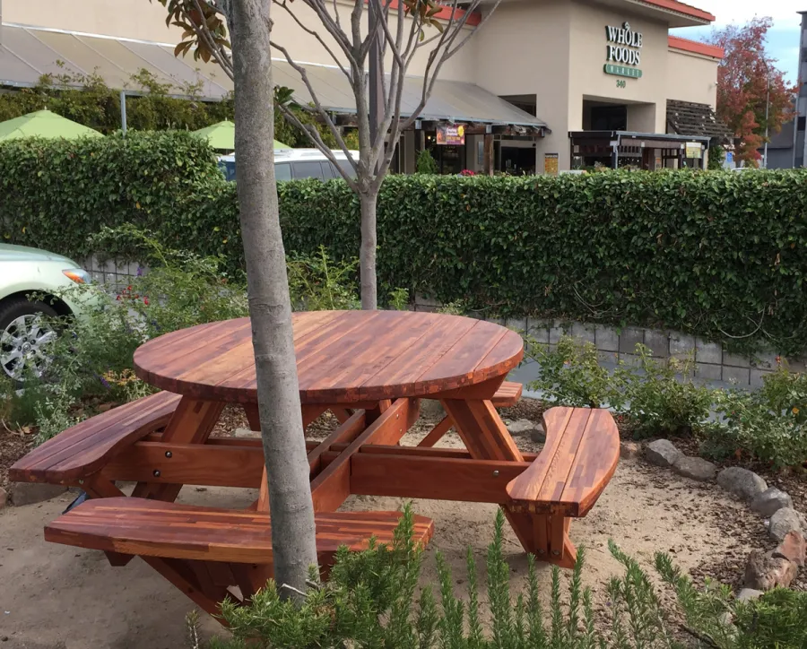 Round Wooden Picnic Tables (Attached Benches) (Options: 5' Diameter, Attached Benches, Mosaic Redwood, Standard Tabletop, No Lazy Susan, Umbrella Hole & Plug, Transparent Premium Sealant). Photo Courtesy of Whole Foods Market of San Rafael, CA.