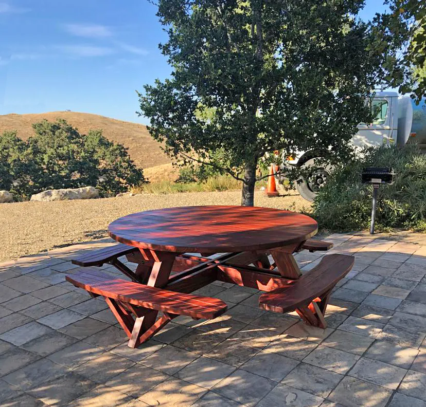 Round Wooden Picnic Tables (Attached Benches) (Options: 6' Diameter, Attached Benches, Mature Redwood, Standard Tabletop, No Lazy Susan, 1 5/8" Diameter Umbrella Hole, Transparent Premium Sealant). Photo Courtesy of W. Fry of Lafayette, California.