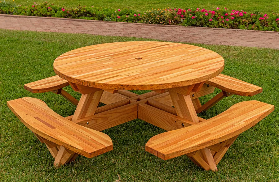 Round Wooden Picnic Table (Attached Benches) (Options: 5' Diameter, Attached Benches, Mosaic Douglas-Fir, Standard Tabletop, No Lazy Susan, 2" Umbrella Hole, Transparent Premium Sealant). Photo courtesy of El Estero Beach Resort in Ensenada, Mexico.