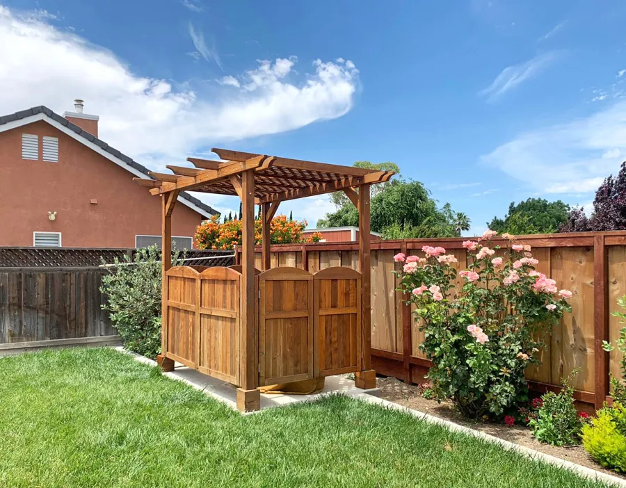 Small Lattice Pergola  (Options: 10' L x 8' W, Custom Gates on 8 ft Side and Custom Panel on the Other Side, California Redwood, No Rain Guard, 8.5 ft Post Height, No Electrical Wiring Kit, No Post Decorative Trim, 4-Post Anchor Kit for Concrete, No Curtain Rods, No Retractable Shade Canopy, Transparent Premium Sealant). Photo Courtesy of C. Malcolm of Tracy, California.