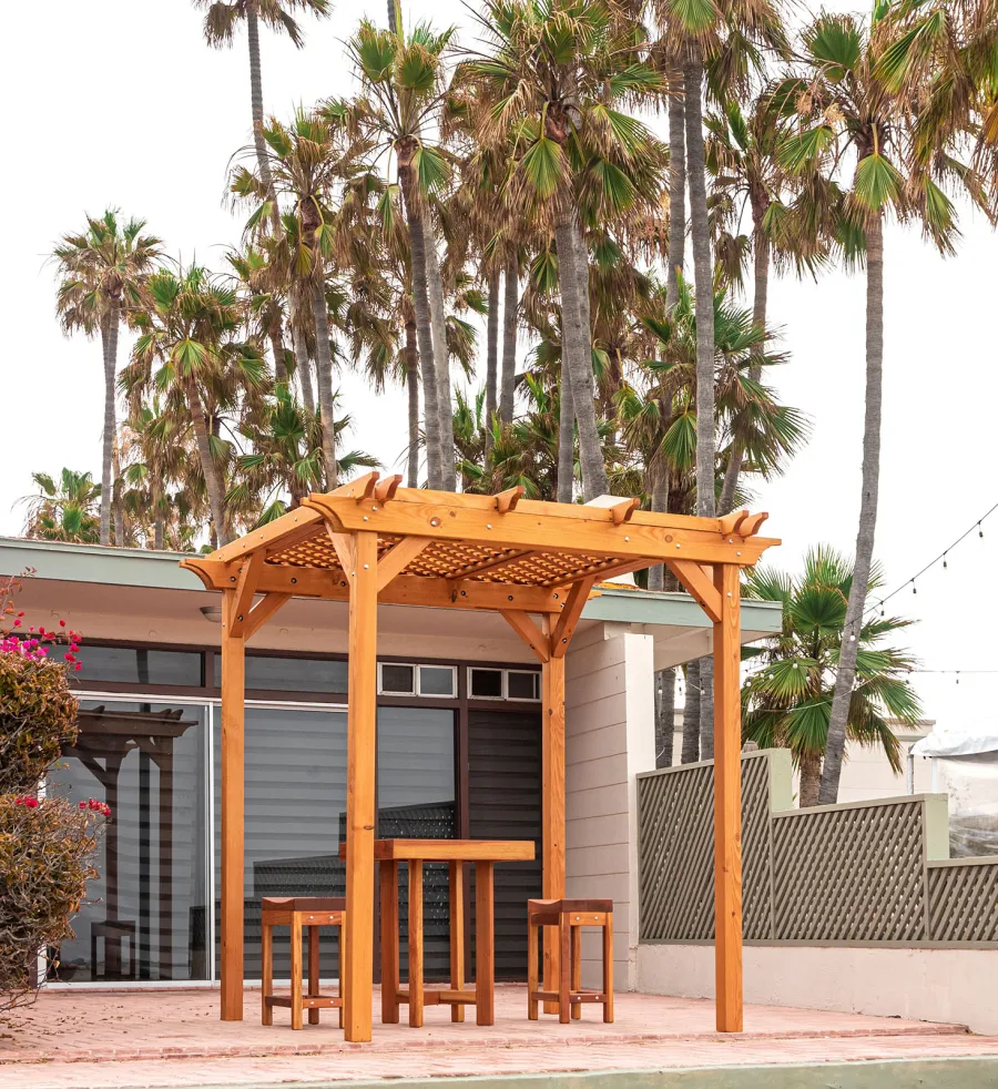 Small Lattice Pergola  (Options: 8' L x 8' W, No Privacy Panels, Douglas-fir, No Rain Guard, 8 ft Post Height, No Electrical Wiring Kit, No Post Decorative Trim, No Anchor Kit, No Curtain Rods, No Retractable Shade Canopy, Transparent Premium Sealant). Glady's Balcony Table Set Under the Pergola.
