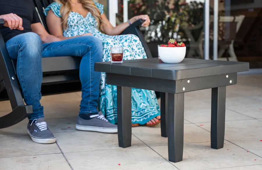 Square Side Table (Options: 23" Size, Mature Redwood, Rounded Corners, 18" H, Black Stain Premium Sealant) with a Massive Rocking Bench.