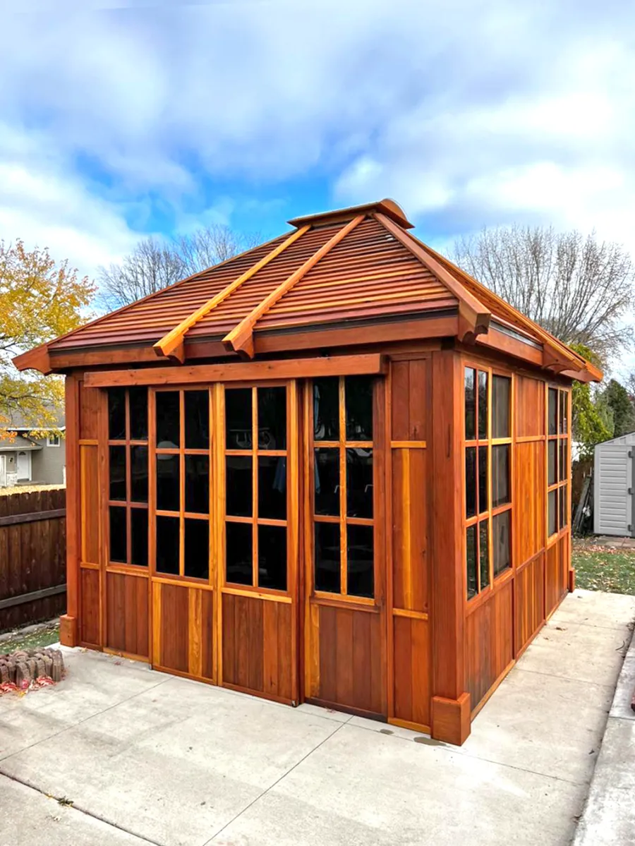 Custom Spa Gazebo Kit (Options: 12' L, 12' W, California Redwood, Combination of Fixed and Sliding Windows, 2' x 4' Skylight, 30" H Siding Below Windows, Vertical Siding, Japanese Doors with Screens, Custom Pitch, Shiplap Roof, No Flooring, Transparent Premium Sealant). Photo Courtesy of A. Calatayud of Savage, MN.