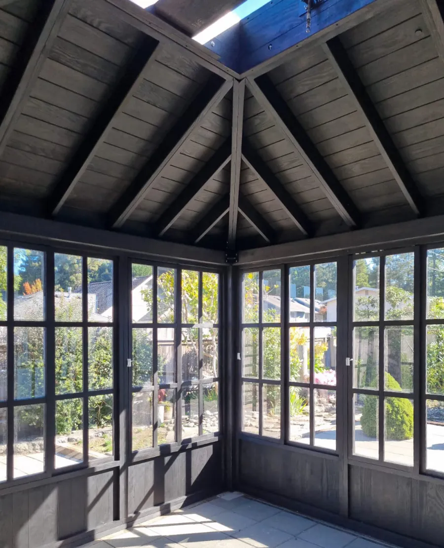 Spa Gazebo Kit (Options: 14' L, 14' W, Douglas-Fir, All Sliding Windows with Screens, 4' x 4' Skylight, 24" H Siding Below Windows, Vertical Siding, French Doors Without Screen, No Flooring, Black Stain Premium Sealant). Photo Courtesy of S. Mortensen of Eureka, CA.
