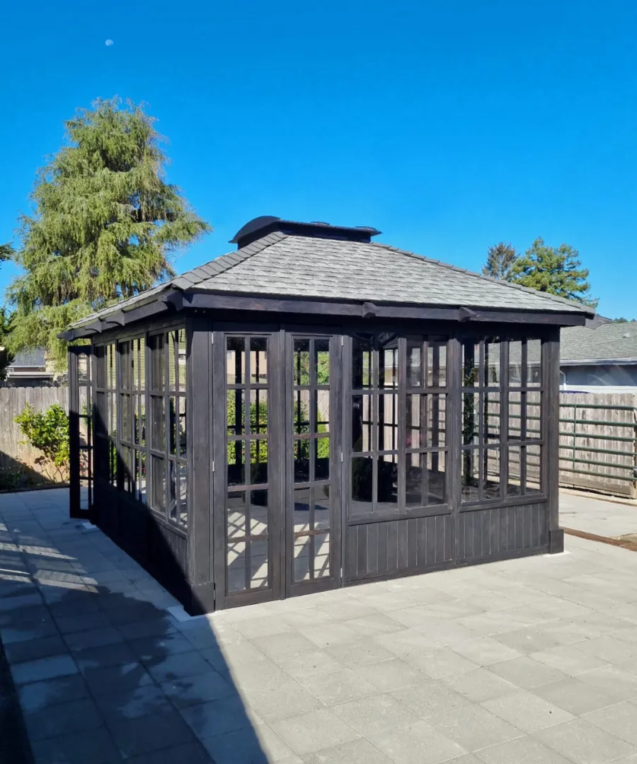 Spa Gazebo Kit (Options: 14' L, 14' W, Douglas-Fir, All Sliding Windows with Screens, 4' x 4' Skylight, 24" H Siding Below Windows, Vertical Siding, French Doors Without Screen, No Flooring, Black Stain Premium Sealant). Photo Courtesy of S. Mortensen of Eureka, CA.