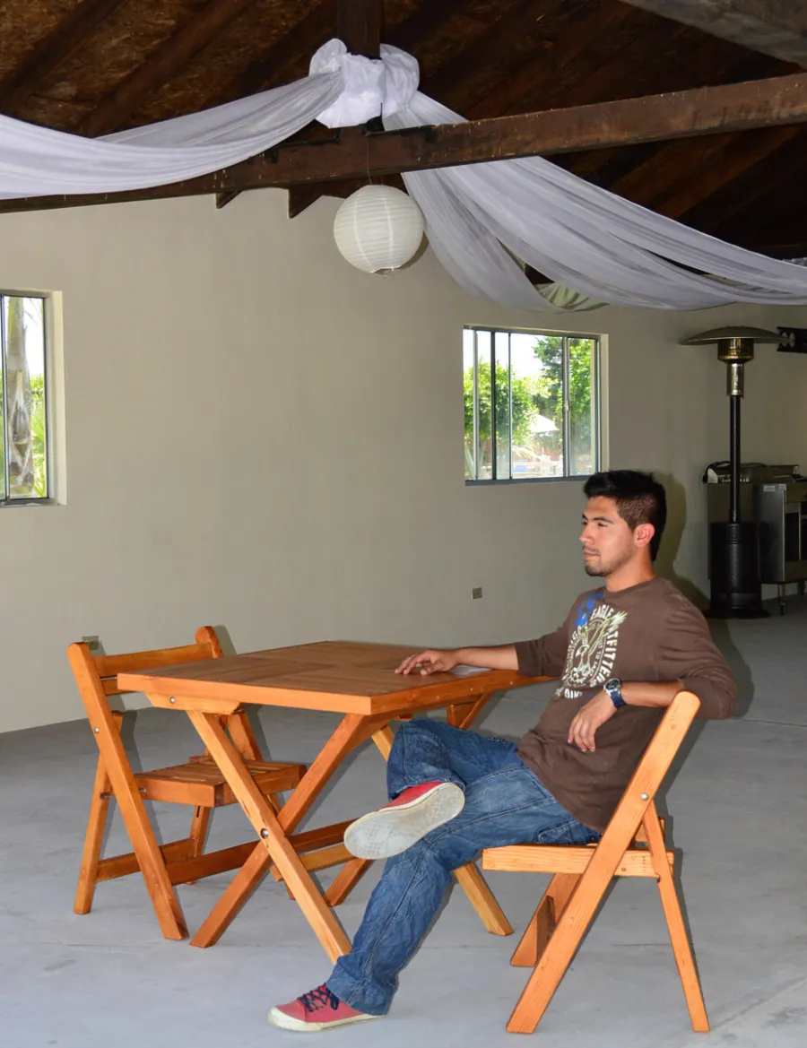 Square Wooden Folding Table (Options: 2 Folding Chairs, Douglas-fir, No Cushions, Standard Tabletop, Checkerboard Design, Rounded Corners, No Umbrella Hole, Transparent Premium Sealant). Photo Courtesy of El Laurel, Ensenada, Mexico.