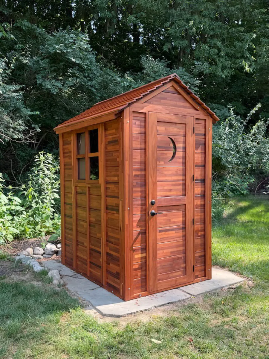 Storage Mini Barns (Options: 6' W, 4.5' D, 8' H, Mosaic Mature Redwood, Single Door, with 2 Ventilation Windows with Screens by Custom Request, 1 Shelf, Deck Flooring, Transparent Premium Sealant). Crescent Moon Cutout was Optional Request by Customer. Photo Courtsy of S. & K. Ehrsam of Washington, IL.