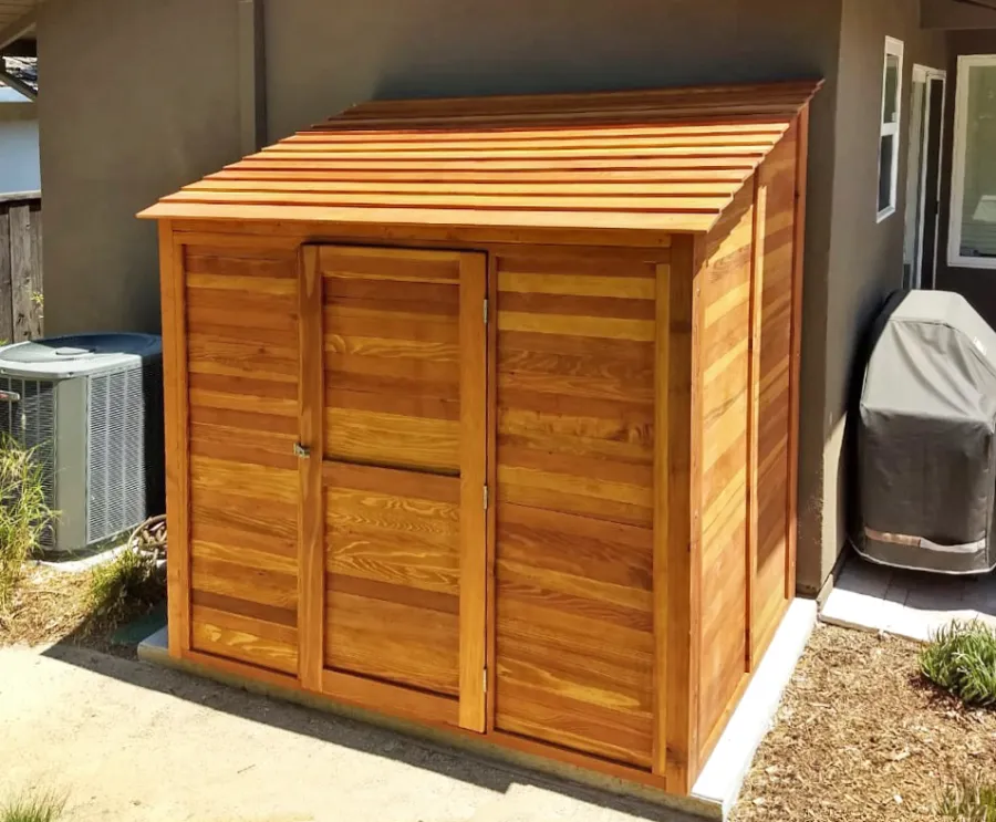 Storage Sheds (Options: 7' W, 4.5' D, 7' H, California Redwood, Single Door, One Shelf on the Side Opposite the Door, 42" H, Transparent Premium Sealant). Photo Courtesy of J. Lewis of Mountain View, CA.