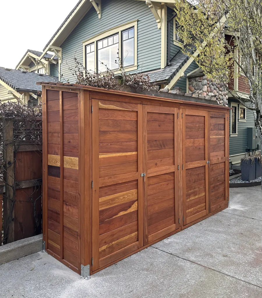 Storage Shed (Options: 12' W, 3' D, 7' H, California Redwood, Double Doors Opening Out From Center, No Shelving, with Interior Flooring, Hardware Kit for Concrete, Transparent Premium Sealant). Photo Courtesy of K. Bennett of Portland, OR.