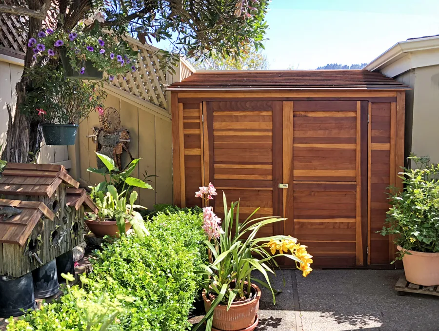 Storage Sheds (Options: 7' W, 4.5' D, 7' H, California Redwood, Double Doors, No Shelving, With Deck, Transparent Premium Sealant). Photo Courtesy of I. Speiser of Carmel, CA