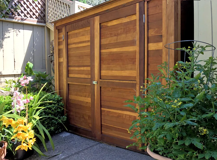 Storage Sheds (Options: 7' W, 4.5' D, 7' H, California Redwood, Double Doors, No Shelving, With Deck, Transparent Premium Sealant). Photo Courtesy of I. Speiser of Carmel, CA