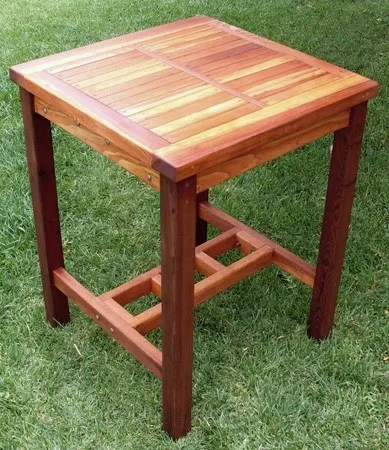 3 GRADES OF REDWOOD SHOWN. Terrace Wood Cocktail Table (Options: Square Cocktail Table, No Seating, 42" H, Slatted Tabletop, Squared Corners, Transparent Premium Sealant). Dark legs: Old-Growth, supports near the ground in-between the legs: Mature Redwood and tabletop: Redwood.