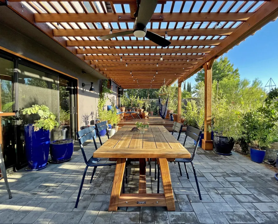 Classic Redwood Patio Table (Options: 6' L x 34 1/2" W, Mature Redwood, No Seating, Old Country Tabletop, Standard, Slightly Rounded Corners, No Umbrella Hole, Transparent Premium Sealant). Table Installed Under an Attached Garden Pergola. Photo Taken 1 Year After Installation. Photo Courtesy of D. Herman of Livermore, CA.