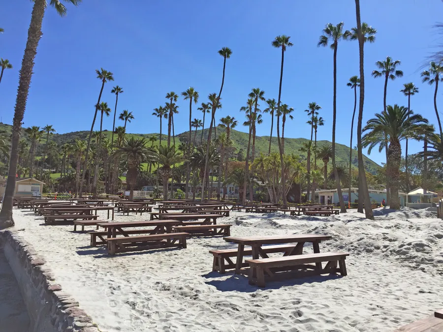 Classic Redwood Patio Table (Options: California Redwood, Side Benches, 1 Full Length Bench Per Side, Standard Tabletop, Slightly Rounded Corners, No Umbrella Hole, Coffee Stain Premium Sealant). Photo Shows Customized Version of Patio Tables. Tables Installed in Catalina Island, CA.
