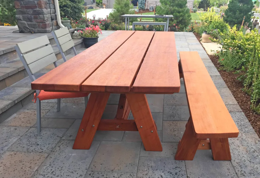 Classic Redwood Patio Table (Options: 8' L, 34 ½" W, Side Bench, Mature Redwood, 1 Full Length Side Bench on One Side, Custom Tabletop [3-Plank Bookmatch Top], Slightly Rounded Corners, No Umbrella Hole, Transparent Premium Sealant). Photo Courtesy of J. Gannon of Broomfield, CO.