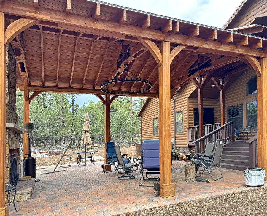 Esther Scissor Truss Pavilion (Options: 22’ L x 18’ W, Mosaic Douglas-Fir, Standard 3/4" T&G Roof Boards, 9.5' H Posts, No Ceiling Fan Base, 6 High-Wind Post Anchors, Cutout to fit Chimney on the Back, Transparent Premium Sealant). Photo Courtesy of H. O'Riley of Lakeside, AZ.