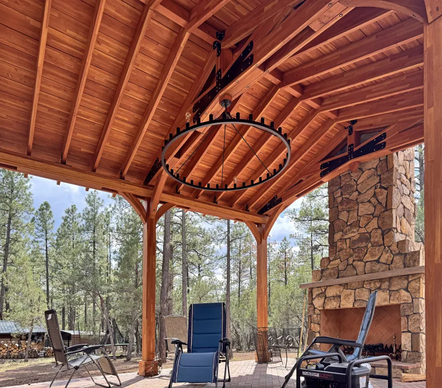 Esther Scissor Truss Pavilion (Options: 22’ L x 18’ W, Mosaic Douglas-Fir, Standard 3/4" T&G Roof Boards, 9.5' H Posts, No Ceiling Fan Base, 6 High-Wind Post Anchors, Cutout to fit Chimney on the Back, Transparent Premium Sealant). Photo Courtesy of H. O'Riley of Lakeside, AZ.