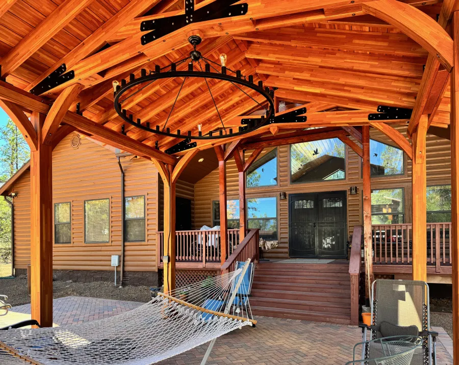 Esther Scissor Truss Pavilion (Options: 22’ L x 18’ W, Mosaic Douglas-Fir, Standard 3/4" T&G Roof Boards, 9.5' H Posts, No Ceiling Fan Base, 6 High-Wind Post Anchors, Cutout to fit Chimney on the Back, Transparent Premium Sealant). Photo Courtesy of H. O'Riley of Lakeside, AZ.