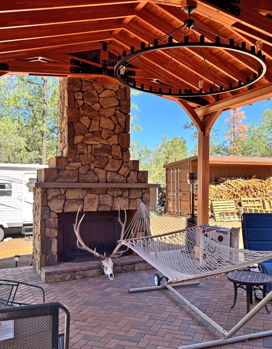 Esther Scissor Truss Pavilion (Options: 22’ L x 18’ W, Mosaic Douglas-Fir, Standard 3/4" T&G Roof Boards, 9.5' H Posts, No Ceiling Fan Base, 6 High-Wind Post Anchors, Cutout to fit Chimney on the Back, Transparent Premium Sealant). Photo Courtesy of H. O'Riley of Lakeside, AZ.