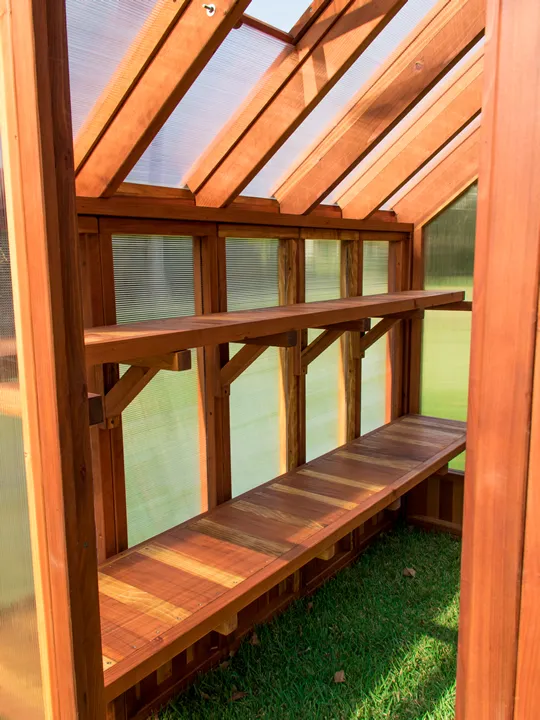 The Forever Hot House (Options: 8 ft L x 6 ft W, California Redwood, 2 shelves long, Transparent Premium Sealant). This Forever Hot House was assembled on a lawn for a photo shoot. We recommend installation be on a developed hardscape of your choosing and not bare soil or lawn.