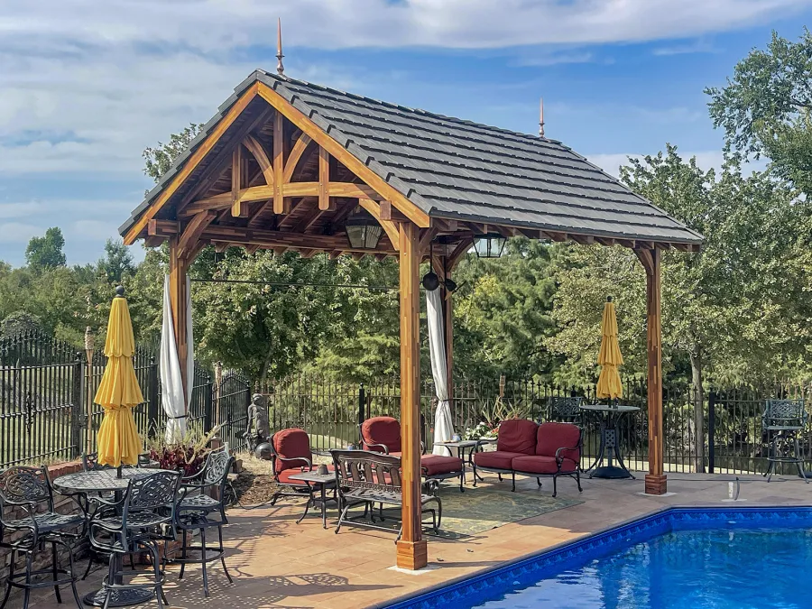Custom Granada Pavilion (Options: 20 ft x 15 ft, Mosaic Redwood, 4-Post Anchor Kit for High-Wind, No Fascia Board, No Curtain Rods, 3 Ceiling Fan Bases, Transparent Premium Sealant). Shake from DaVinci Roof [https://www.davinciroofscapes.com/]. Photo Courtesy of K. Lowe of Newcastle, Oklahoma.