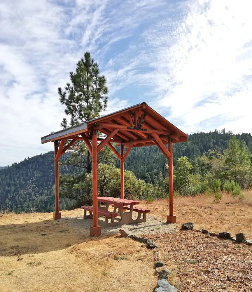 Humboldt Log Pavilion (Options: 6in x 6in Posts Thickness, 12ft L x 12ft W, No Privacy Panels, California Redwood, 2 Fascia Boards for Gutters, 9.5ft Post Height, No Electrical Wiring Trim, 4-Post Anchor Kit for High-Wind, No Ceiling Fan Fan Bases, No Curtain Rods, Transparent Premium Sealant). Metal Roof Installed by Custom Request.