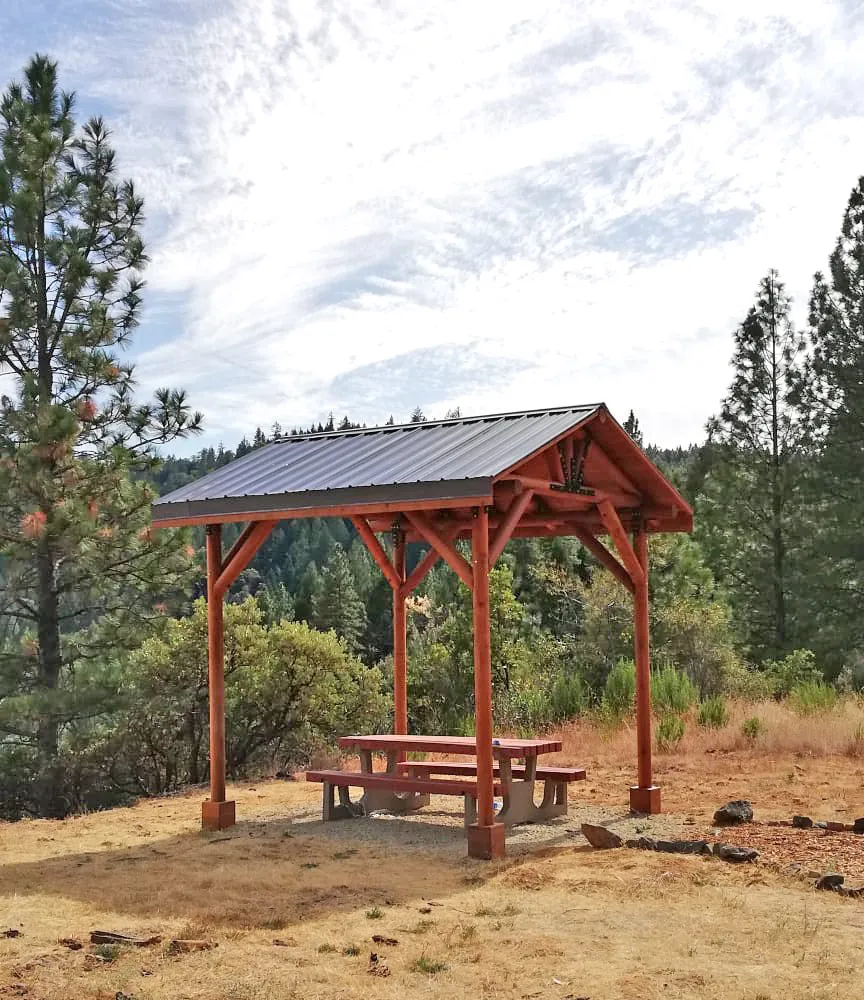 Humboldt Log Pavilion (Options: 6in x 6in Posts Thickness, 12ft L x 12ft W, No Privacy Panels, California Redwood, 2 Fascia Boards for Gutters, 9.5ft Post Height, No Electrical Wiring Trim, 4-Post Anchor Kit for High-Wind, No Ceiling Fan Fan Bases, No Curtain Rods, Transparent Premium Sealant). Metal Roof Installed by Custom Request.
