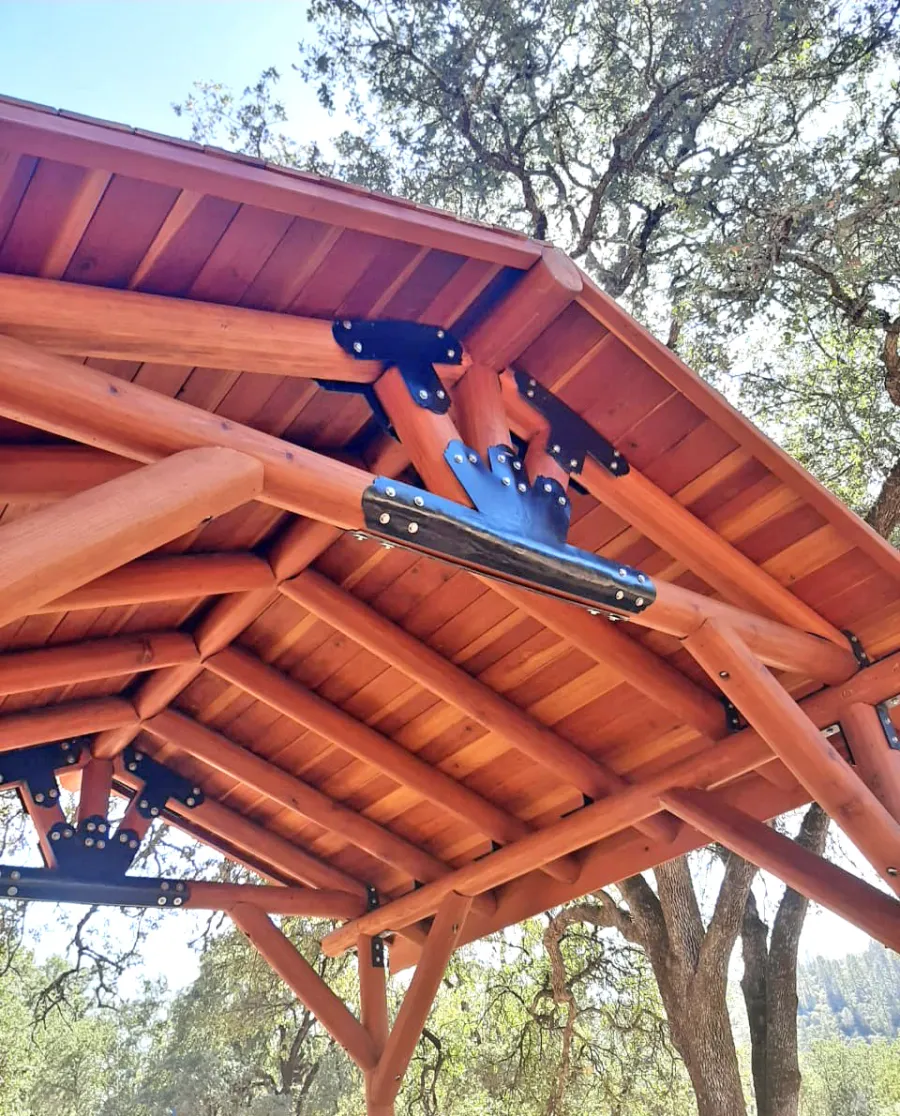Humboldt Log Pavilion (Options: 6in x 6in Posts Thickness, 12ft L x 12ft W, No Privacy Panels, California Redwood, 2 Fascia Boards for Gutters, 9.5ft Post Height, No Electrical Wiring Trim, 4-Post Anchor Kit for High-Wind, No Ceiling Fan Fan Bases, No Curtain Rods, Transparent Premium Sealant). Metal Roof Installed by Custom Request.