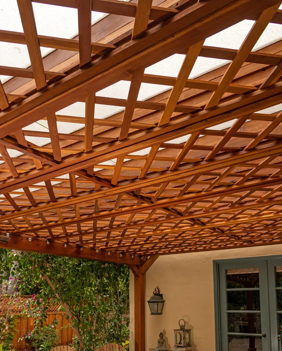 Custom Lattice Pergola Kit (Options: 19' L x 16' W, California Redwood, Electrical Wiring Trim for 2 Posts, 4-Post Kit for Concrete, No Ceiling Fan Base, No Privacy Panels, No Curtain Rods, 9' Post Height, Transparent Premium Sealant). Lattice panels were customized with larger openings than is the standard design. Photo Courtesy of D. Wood of Palo Alto, California.