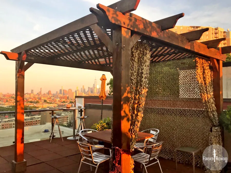 Add Some Fabric For a Special Touch. Lattice Pergola Kit (Options: 10' x 10', Mature Redwood, No Electrical Wiring Trim, 4-Post Anchor Kit for Concrete, No Ceiling Fan Base, No Privacy Panels, No Curtain Rods, 9' Post Height, Transparent Premium Sealant). Photo Courtesy of Fabienne Jacquet of Union City, New Jersey.