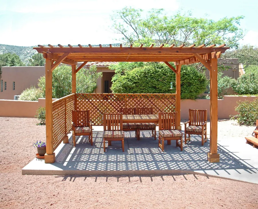 Lattice Pergola Kit (Options: 15' x 15', California Redwood, No Electrical Wiring Trim, 4-post Anchor Kit for Concrete, No Ceiling Fan Base, 2 Privacy Panels, No Curtain Rods, 9' Post Height, Transparent Premium Sealant). 2x2 Slats Above Rafters was Added as Custom Detail. It is not Part of Standard Design. Under the Pergola, a 7' San Francisco Patio Table Set with 42" W Tabletop, 4 Ruth Chairs and 2 Ruth Armchairs. Photo Courtesy of Mr. Joseph Dlugosz of Sedona, AZ.