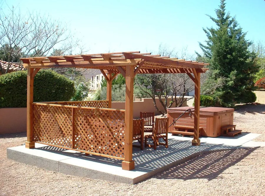 Lattice Pergola Kit (Options: 15' x 15', California Redwood, No Electrical Wiring Trim, 4-post Anchor Kit for Concrete, No Ceiling Fan Base, 2 Privacy Panels, No Curtain Rods, 9' Post Height, Transparent Premium Sealant). 2x2 Slats Above Rafters was Added as Custom Detail. It is not Part of Standard Design. Under the Pergola, a 7' San Francisco Patio Table Set with 42" W Tabletop, 4 Ruth Chairs and 2 Ruth Armchairs. Photo Courtesy of Mr. Joseph Dlugosz of Sedona, AZ.