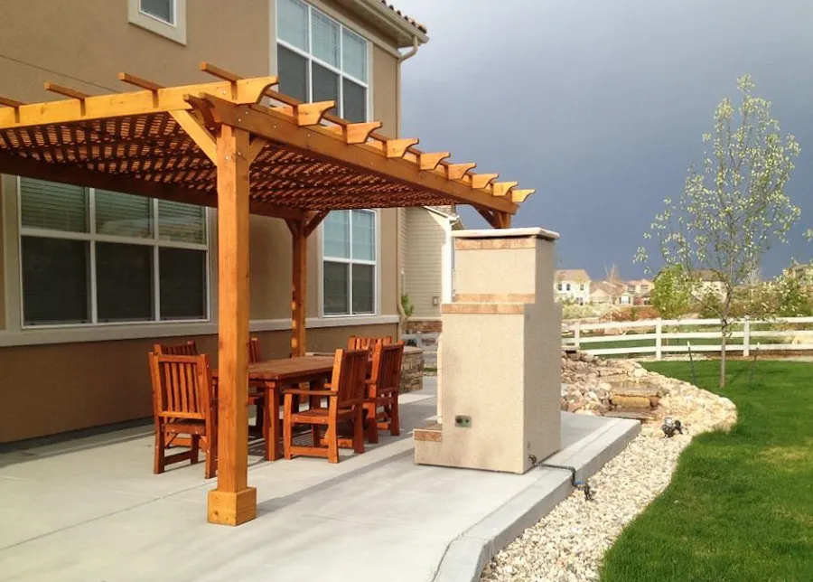 Lattice Pergola Kit (Options: 20' L x 12' W, Mature Redwood, No Electrical Wiring Trim, Lengthwise Roof Support Timbers, 4-Post Anchor Kit for Concrete, No Ceiling Fan Base, No Privacy Panels, No Curtain Rods, 9.5' Post Height, Transparent Premium Sealant). 2x2 Slats Above Rafters was Added as Custom Detail. It is not Part of Standard Design. 