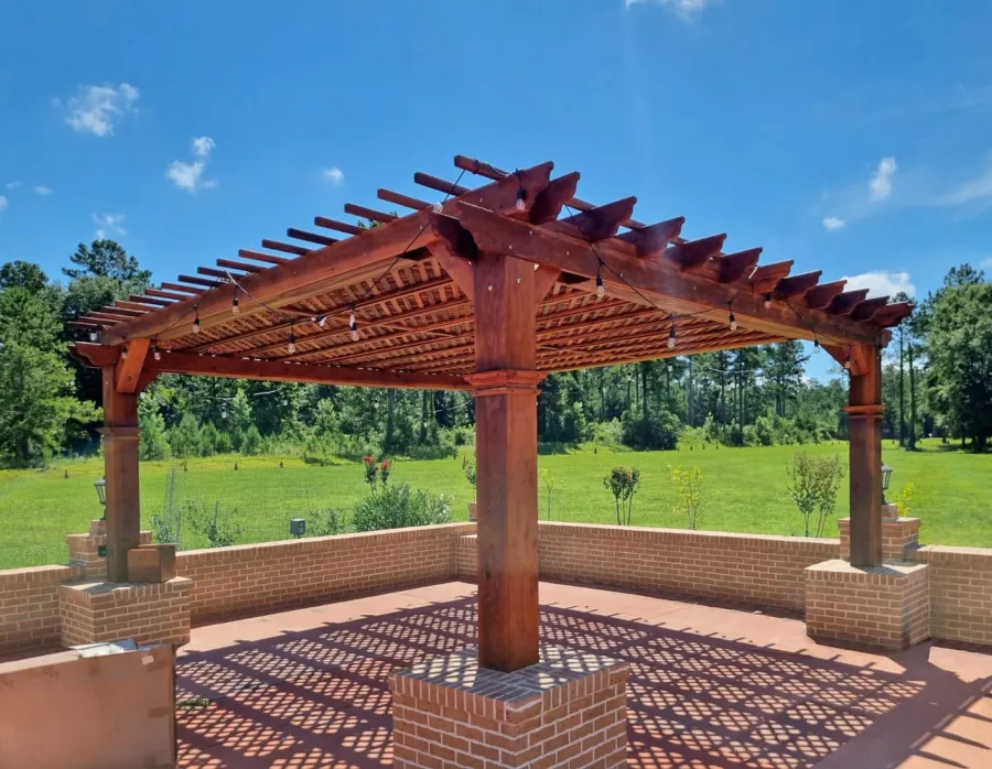 Custom Lattice Pergola Kit (Options: 20' L x 20' W, California Redwood, No Electrical Wiring Trim, Lengthwise Roof Support Timbers, 4-Post Anchor Kit for High-Wind, No ceiling Fan Base, No Privacy Panels, Horizontal Post Decorative Trims, 9.5' Post Height, Transparent Premium Sealant). 2x2 Slats Above Rafters Added by Custom Request. Customer envloved the lower part of the posts with masonry.