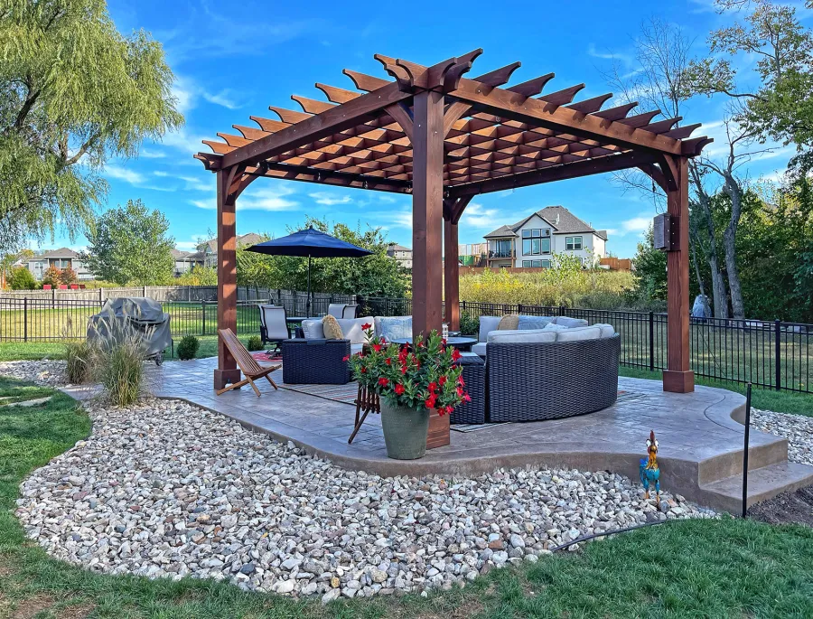 Montvale Pergolas (Options: 16' x 16', Douglas-fir, 10 ft H, 1 Ceiling Fan Base, No Post Decorative Trims, Coffee-Stain Premium Sealant). Photo Courtesy of Billy & Brianne Foster of Olathe, KS.