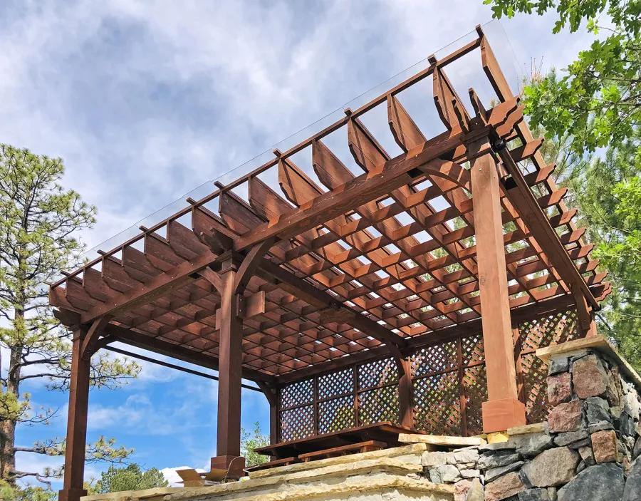 Montvale Pergolas (Options: 24' x 16', Mature Redwood, 6-Post Anchor Kit for Concrete, 1 Ceiling Fan Base and 1 T.V. Base, 2 Curtain Rods, 1 Lattice Privacy Panel, 9.5' H Posts, with Rain Guard, Coffee-Stain Premium Sealant). A Forever Picnic Table Set with Unattached Benches Shown Under the Pergola. Photo Courtesy of J. Brinkman of Castle Rock, Colorado.