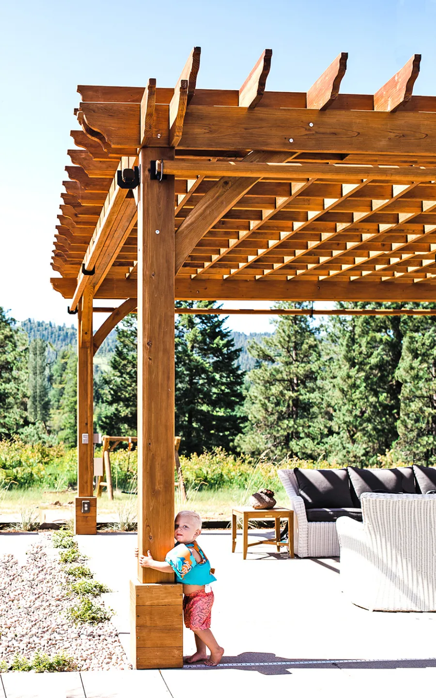 Montvale Pergolas  (Options: 22' x 22', Mature Redwood, 4-Post Anchor Kit for Concrete, Electrical Wiring Trim Kit for 4 Posts, No Ceiling Fan Base, 4 Curtain Rods, No Privacy Panels, 10' Post, Transparent Premium Sealant). Photo Courtesy of J. Scott of Coeur deline, Idaho.