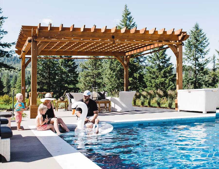 Montvale Pergolas  (Options: 22' x 22', Mature Redwood, 4-Post Anchor Kit for Concrete, Electrical Wiring Trim Kit for 4 Posts, No Ceiling Fan Base, 4 Curtain Rods, No Privacy Panels, 10' Post, Transparent Premium Sealant). Photo Courtesy of J. Scott of Coeur deline, Idaho.