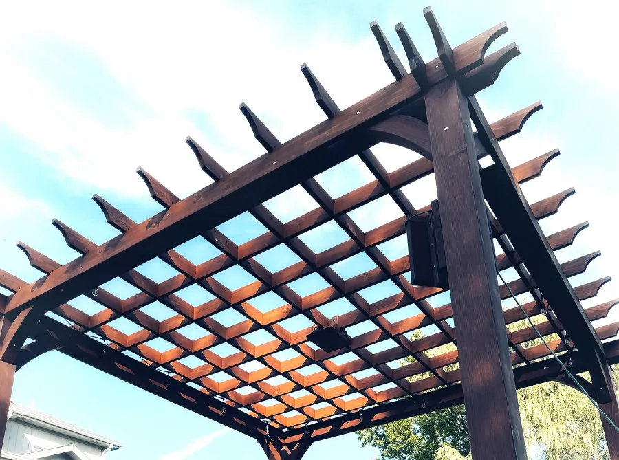 Montvale Pergolas (Options: 16' x 16', Douglas-fir, 10 ft H, 1 Ceiling Fan Base, No Post Decorative Trims, Coffee-Stain Premium Sealant). Photo Courtesy of Billy & Brianne Foster of Olathe, KS.