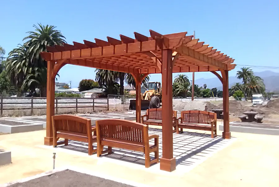 Montvale Pergolas (Options: 16' x 20', Mature Redwood, 4-Post Anchor Kit for Concrete, No Ceiling Fan Base, No Curtain Rods, No Privacy Panels, 9.5' Post, Transparent Premium Sealant). Photo also shows 4 Luna Memorial Benches. Photos taken in Carpinteria Garden Park during construction, May 10, 2017. Photo Courtesy of Carpinteria Park, 5775 Carpinteria Avenue  Carpinteria, CA  93013.