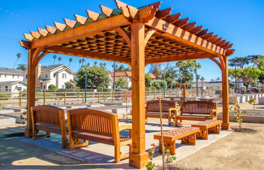Montvale Pergolas (Options: 16' x 20', Mature Redwood, 4-Post Anchor Kit for Concrete, No Ceiling Fan Base, No Curtain Rods, No Privacy Panels, 9.5' Post, Transparent Premium Sealant). Photo also shows some Luna Memorial Benches and Lighthouse Benches. Sunbrella shade fabric above the pergola was ordered from: www.patiolane.com as a custom item. Photo Courtesy of Carpinteria Park, 5775 Carpinteria Avenue  Carpinteria, CA  93013.